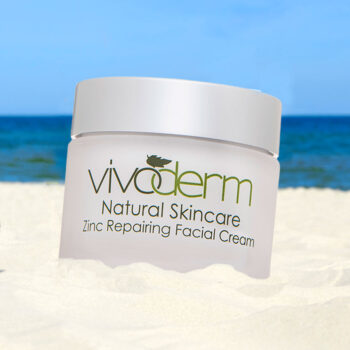 Vivoderm Zinc Repairing Facial Cream with 30 SPF sitting on the sand by the ocean